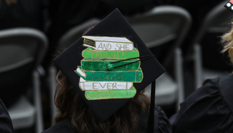 Cap decorated with a painting of a stack of books