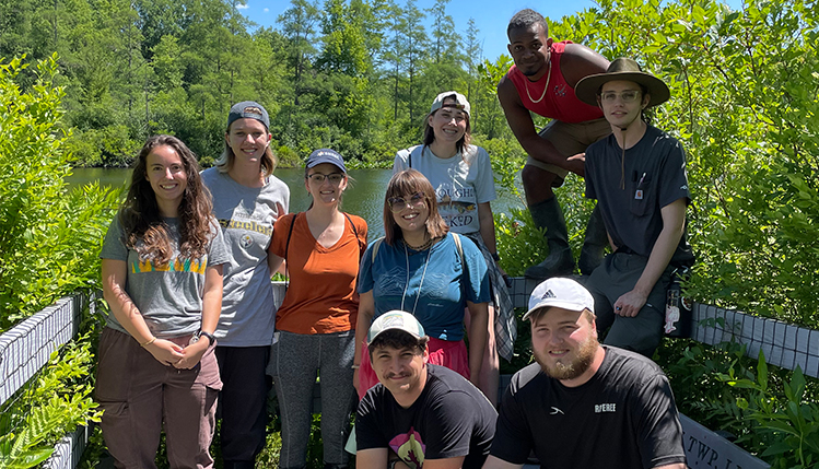 A group of nine SRU students posed in front of nature