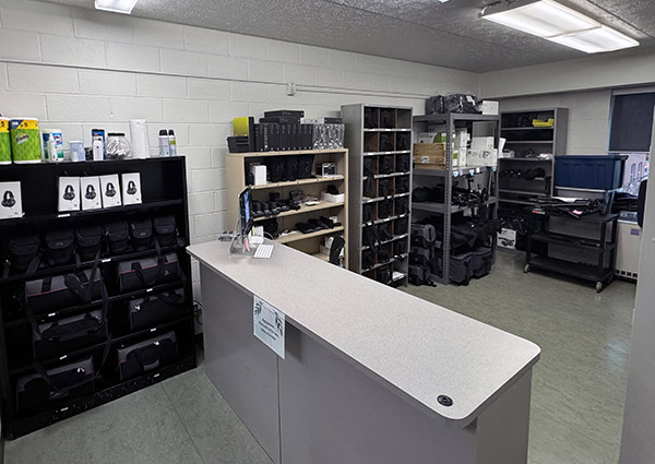 An image depicting a room with storage cabinets along the wall and a service desk in the middle of the room.