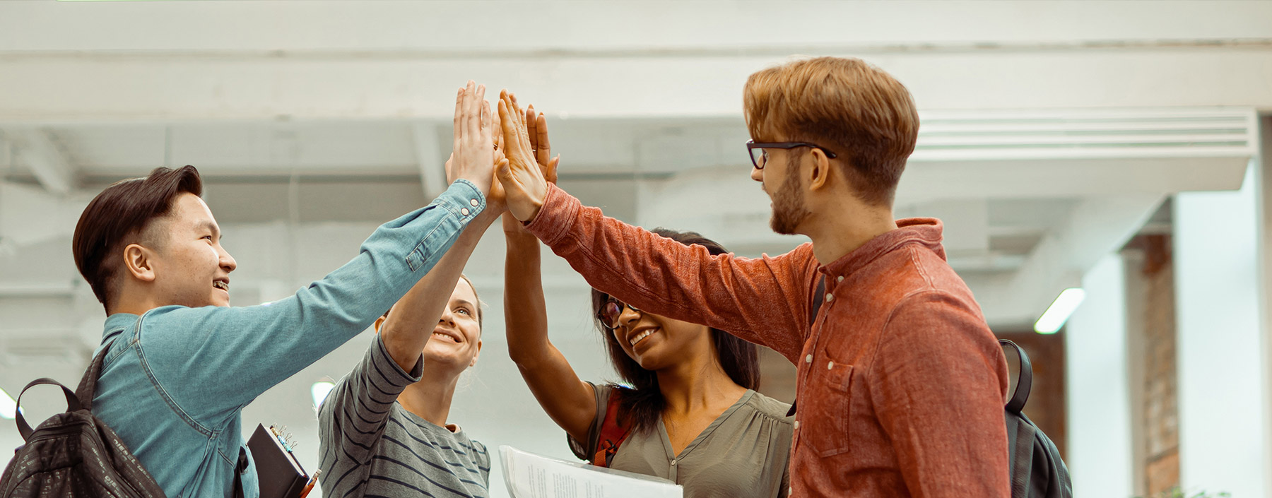 Group of students high-fiving