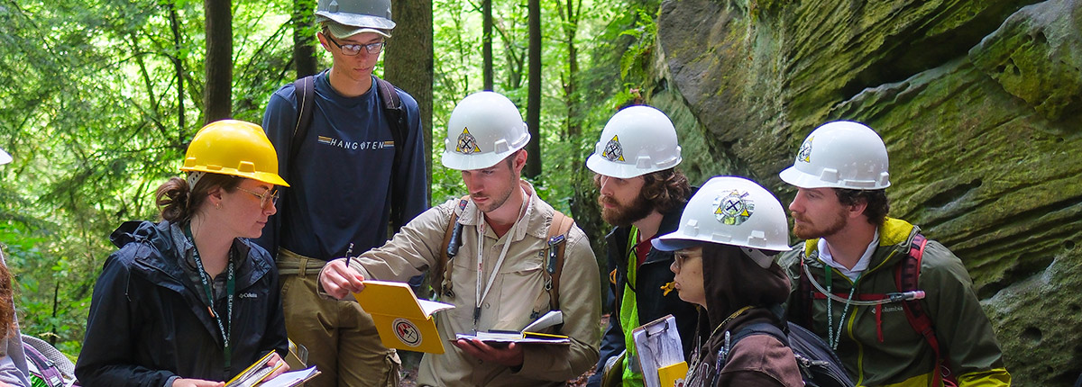 A group of students in a forest doing research