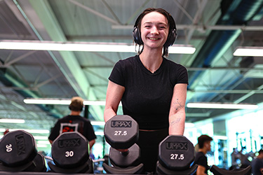 Student lifting dumbbells